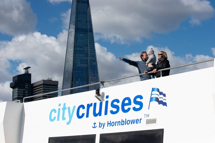 Discover iconic landmarks of London from the open decks of the River Thames One-Way Sightseeing Cruise perfect for families and friends wanting to explore the city from a unique perspective.